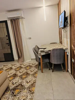 a living room with a table and a rug at THE BESt in Hurghada