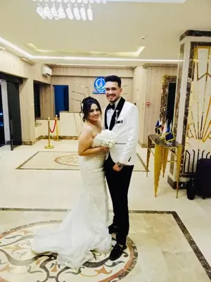 a bride and groom posing for a picture at their wedding at فندق ميريت امون سوهاج in Jazīrat Maḩrūs