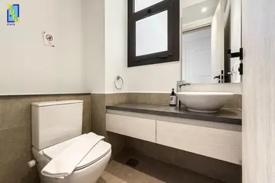 a bathroom with a white toilet and a sink at The 2BDR Blue Horizon Kamaran El Gouna in Hurghada