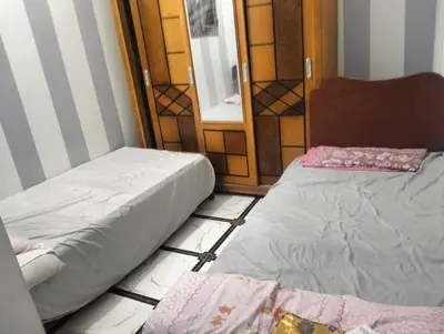 two beds sitting on the floor in a room at Safy Guest House in Aswan