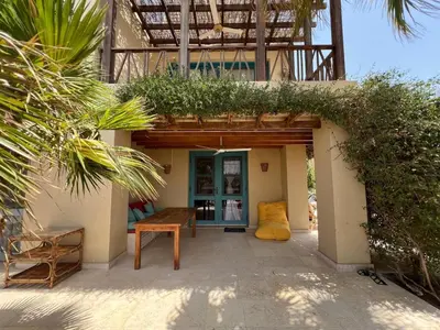 a building with a bench and a plant on it at Lagoon Charm | 1BR in Steigenberger El Gouna in Hurghada