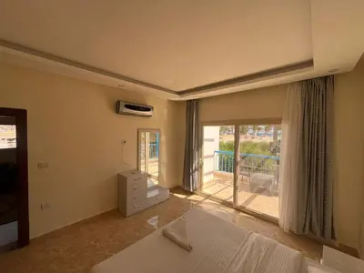 a bedroom with a bed and a balcony at شاليه بمنتجع ميراج Mirage apartments in Hurghada