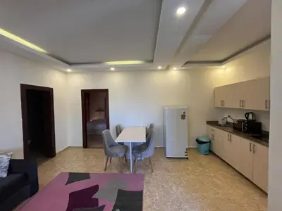 a kitchen with a table and chairs in a room at شاليه بمنتجع ميراج Mirage apartments in Hurghada