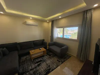 a living room with a couch and a window at شاليه بمنتجع ميراج Mirage apartments in Hurghada