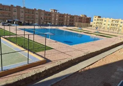 a large swimming pool in a large building at Bay View Sahl Hasheesh Chalet in Hurghada