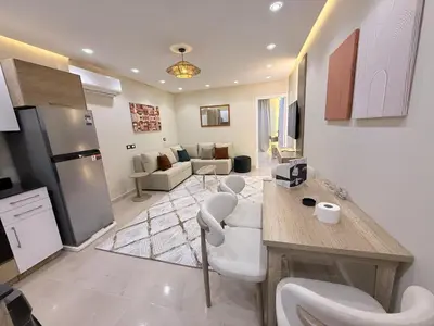 a living room with a kitchen and a living room with at Nubia Beach Resort in Hurghada