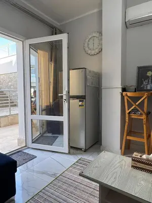a kitchen with a refrigerator and a sliding glass door at Inter Prime apartment 4 in Hurghada
