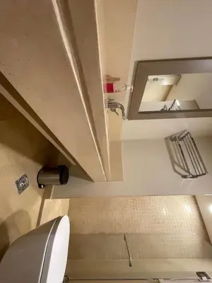 a bathroom with a toilet and a mirror at Mangroovy - 2Br Commodious Pool&Gouna views Condo in Hurghada