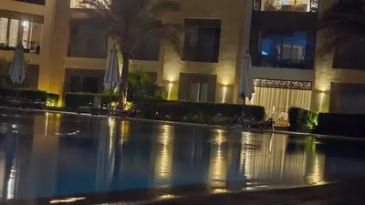 a large swimming pool in a building at night at Mangroovy - 2Br Commodious Pool&Gouna views Condo in Hurghada