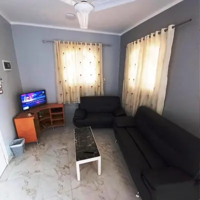 a living room with a couch and a table at family villa private pool in Luxor