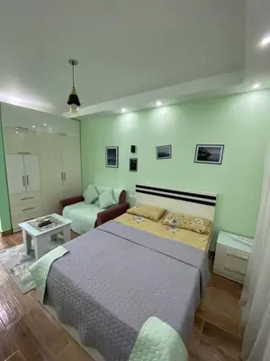 a bedroom with a bed and a living room at فلورينزا الخمسين in Hurghada