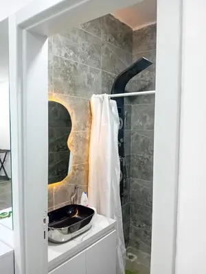 a bathroom with a sink and a shower at Aqua Infinity D306 in Hurghada