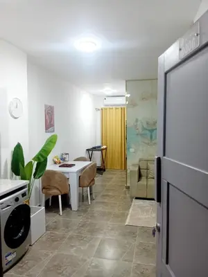 a kitchen and dining room with a table and a refrigerator at Aqua Infinity D306 in Hurghada