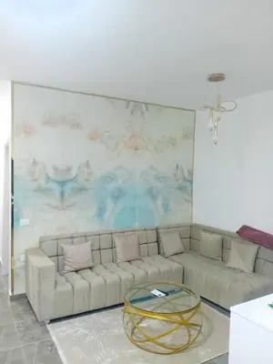 a living room with a couch and a glass table at Aqua Infinity D306 in Hurghada