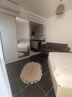 a bedroom with a bed and a couch and a mirror at Royal Beach Resort in Hurghada