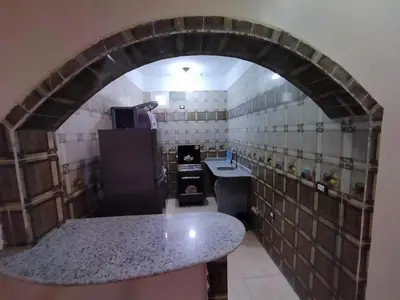 a kitchen with an archway with a counter in a room at SAMA HOUSE Cozy Mountain Hideaway in Luxor in ‘Ezbet Abu Ḥabashi