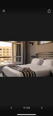 two beds sitting next to each other in a bedroom at Timeshare for rent at sunny days family resort in Hurghada