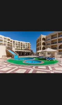 a large swimming pool in front of a building at Timeshare for rent at sunny days family resort in Hurghada