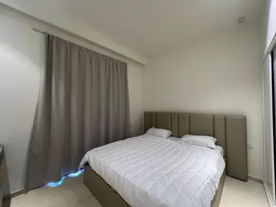 a bedroom with a large bed with white sheets at Stylish 1BR Retreat – Ancient Sands El Gouna in Hurghada