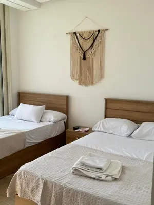 a hotel room with two beds with towels on them at ELGOUNA Maraya duplex pool view in Hurghada