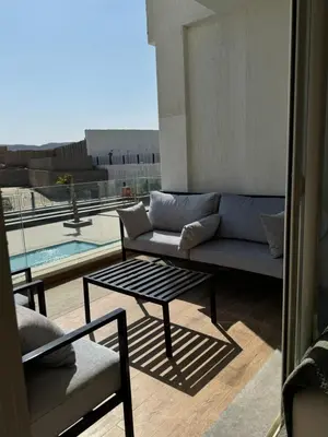 a living room with a couch and a coffee table at ELGOUNA Maraya duplex pool view in Hurghada