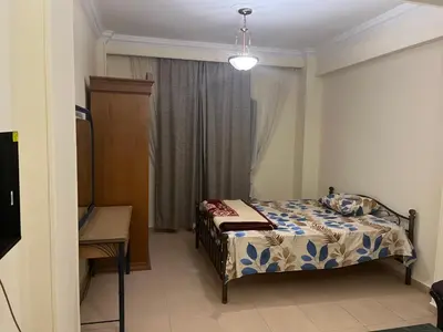 a small bedroom with a bed and a window at Cozy Apartment, on Sheraton Road Near Metro Market in Hurghada