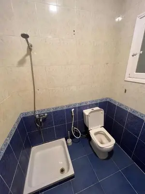 a bathroom with a toilet and a bath tub at Cozy Apartment, on Sheraton Road Near Metro Market in Hurghada