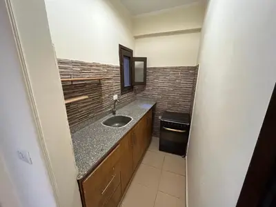 a bathroom with a sink and a counter at Cozy Apartment, on Sheraton Road Near Metro Market in Hurghada