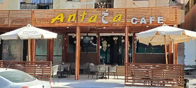 a restaurant with tables and chairs and umbrellas in front at Florenza Resort - Roboost - Hurghada in Hurghada