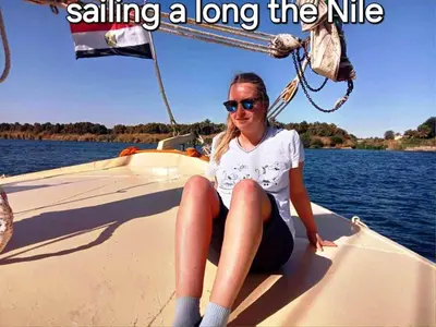 a woman sitting on the bow of a boat at Katadool Boat in Aswan