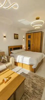 a large bedroom with two beds and a couch at Luxury Studio Pool & Free Private Beach, Close to Airport in Hurghada