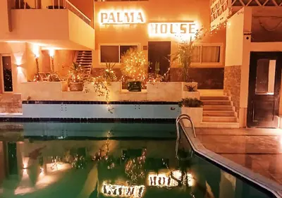 a hotel with a pool in front of a building at Cozy 1BR Pool View Apartment Steps from the Beach in Hurghada