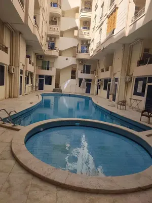 an empty swimming pool in an apartment building at Paradise Vibe Apartment in Hurghada