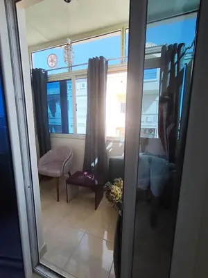 a room with a window and a table and a chair at Paradise Vibe Apartment in Hurghada