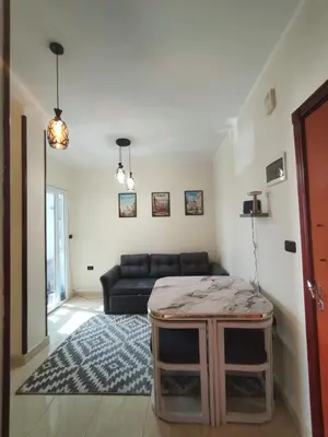 a living room with a couch and a table at Paradise Vibe Apartment in Hurghada