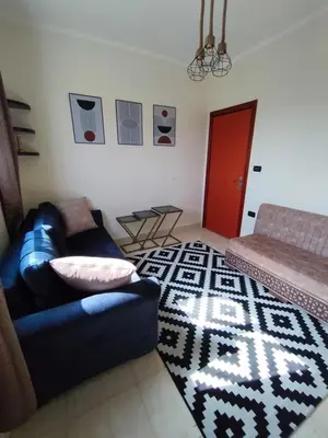 a living room with a couch and a rug at Paradise Vibe Apartment in Hurghada