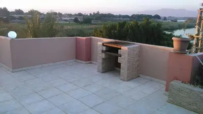 a patio with a bench on the side of a wall at Moon shadow in Luxor