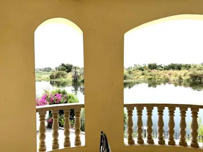 a view from a balcony with a view of a lake at Moon shadow in Luxor