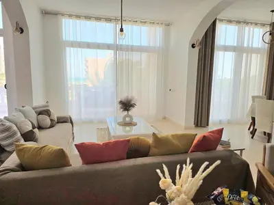a living room with a couch and a table at The White Lions Villa in Hurghada