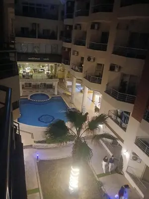 an aerial view of a large building with a palm tree at كذا بلانكا بيتش417 in Hurghada