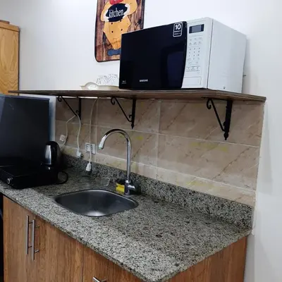 a kitchen counter with a sink and a microwave at كذا بلانكا بيتش417 in Hurghada