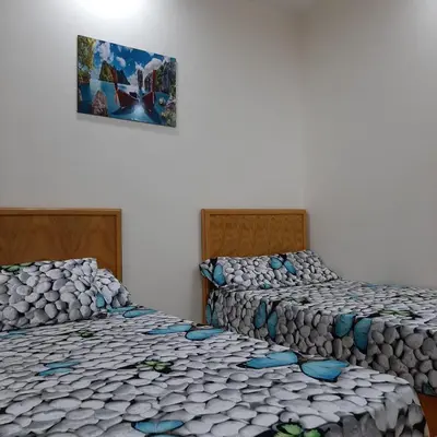 two beds sitting next to each other in a room at كذا بلانكا بيتش417 in Hurghada
