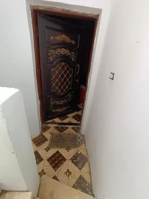 a door in a hallway with a tiled floor at Venti house in Aswan
