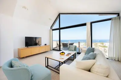 a living room with a white couch and a large window at Luxury Stays in Wadi Jebal Soma Bay in Hurghada