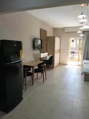 a kitchen and living room with a table and a refrigerator at Karma Aqua Beach in Hurghada