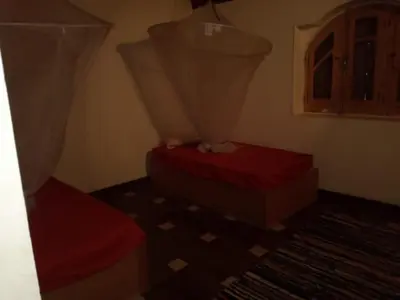 a room with two beds and a window at جزيره سهيل in Aswan
