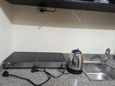 a toaster sitting on a kitchen counter next to a sink at Studio Apartment Flourenza Hurghada in Hurghada