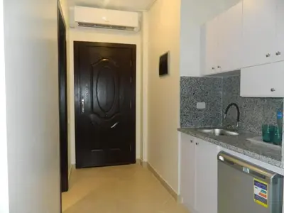 a black door in a kitchen with a sink at Florenza Khamsin Nor in Hurghada