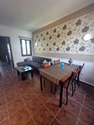 a living room with a table and a couch at Stella Makadi Bay - Balcony Apartment near Pool & Beach - Holiday Makadi in Hurghada