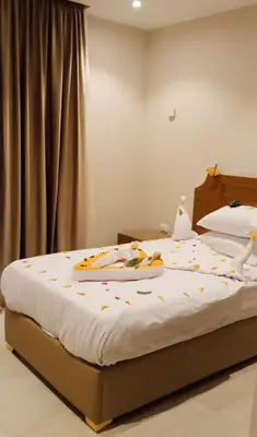 a bed with a tray of food on top of it at La Blanca in Hurghada